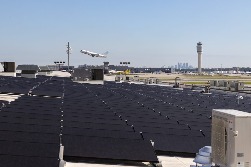 Photo of solar panels as a plane takes off at the Atlanta airport