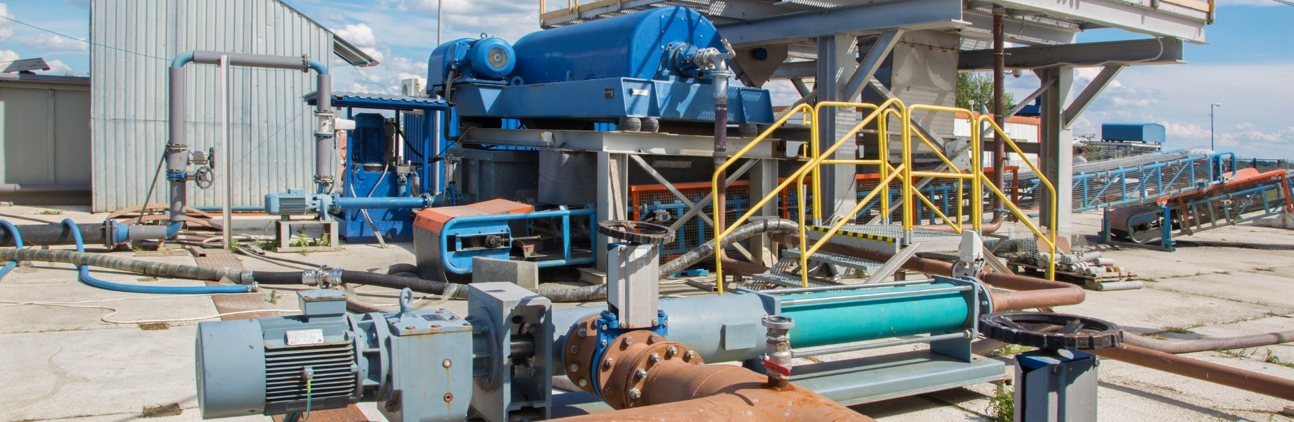 Exterior view of an industrial SBR system, representing a wastewater pretreatment project under construction by ARCO/Murray for a confidential client. Scope includes tanks, piping, and dewatering system infrastructure.